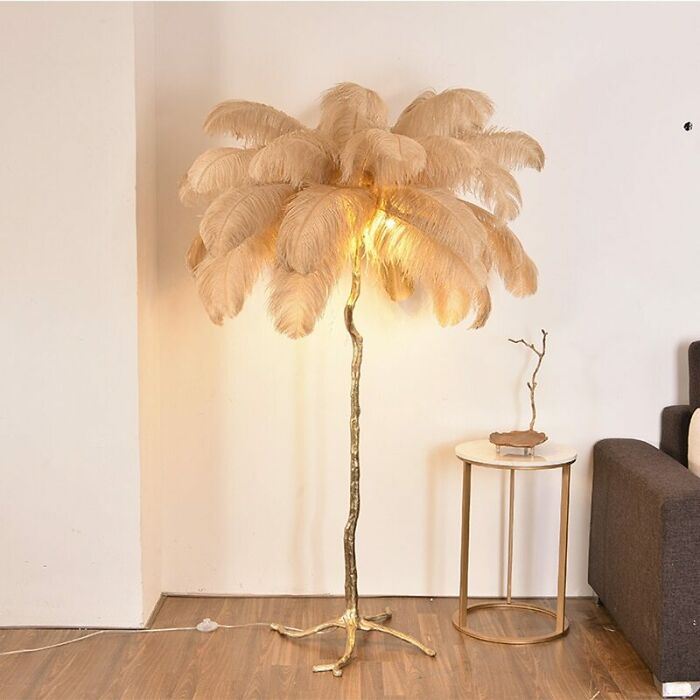 Feathered floor lamp with dust in a living room corner