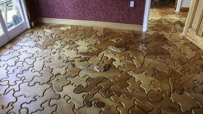 Wooden floor with puzzle piece pattern revealing complicated design concept