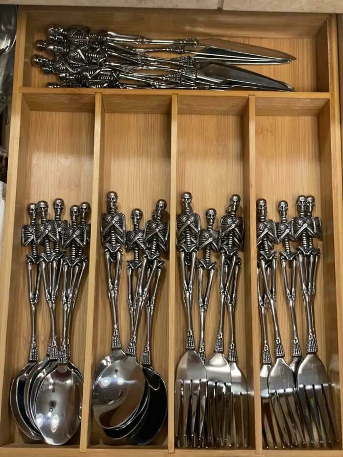 Cutlery drawer with skeleton-shaped handles shows creative but messy design