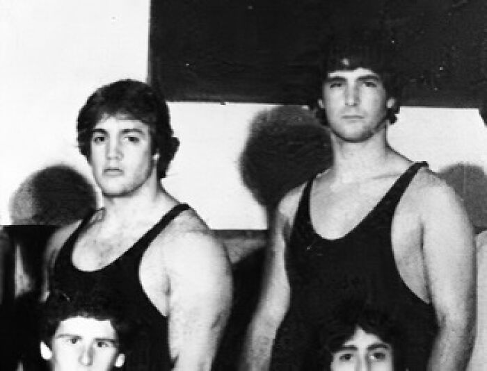 Black and white photo of two young men in wrestling singlets showing celebrity friendships
