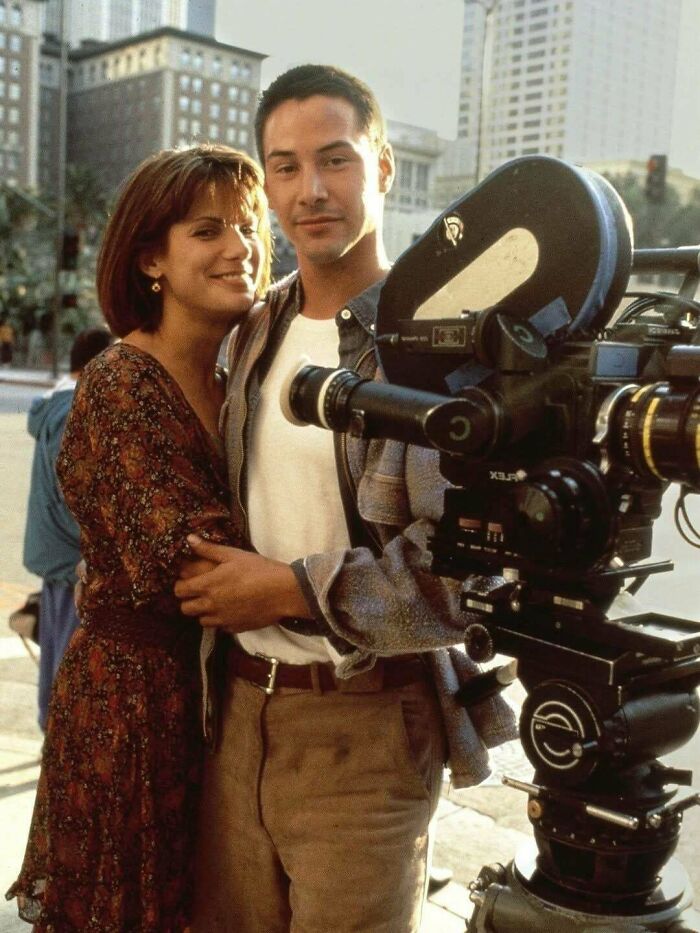 Keanu Reeves and Sandra Bullock on set, a 90s kids movie throwback meme.