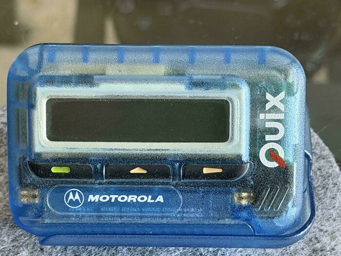 A Motorola Quix pager, a classic piece of older times technology, in a translucent blue case, perfect for retro pics.