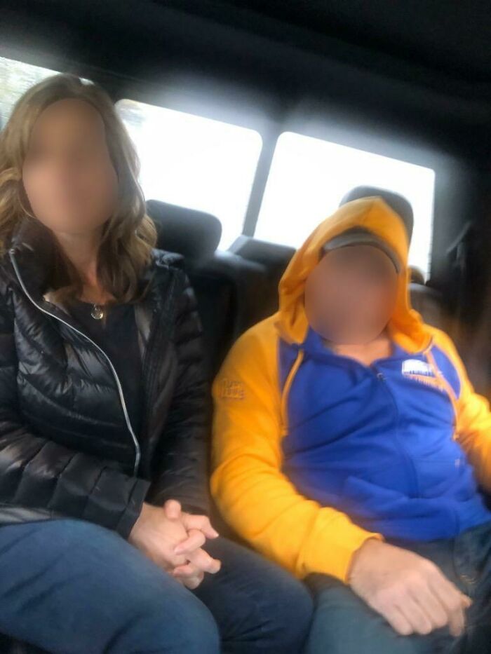 Couple sitting in car, blurred faces for cheating stories context
