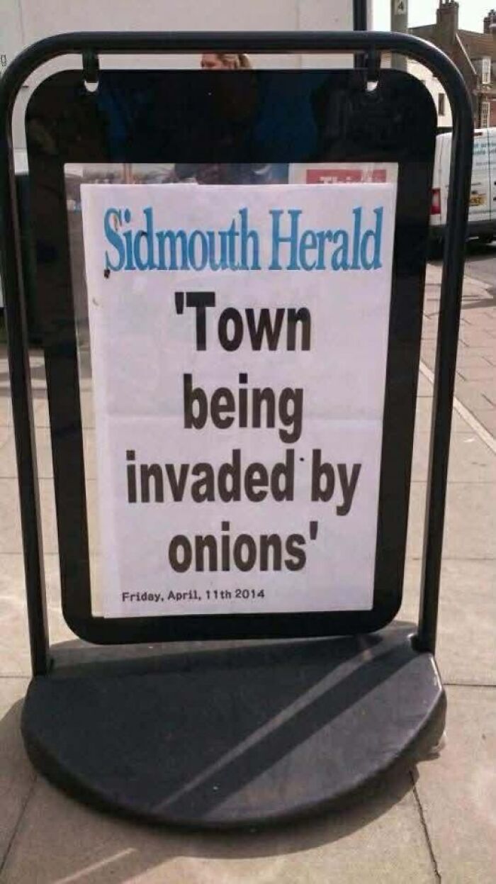 Amusing newspaper sign about town invaded by onions