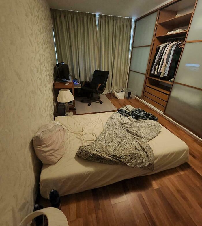 Bedroom with unmade bed and computer desk, illustrating cheating stories context