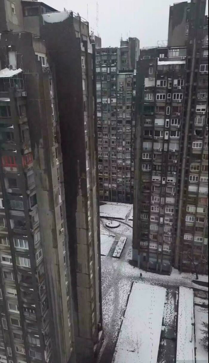 Snow-covered urban hell residential towers with narrow courtyard
