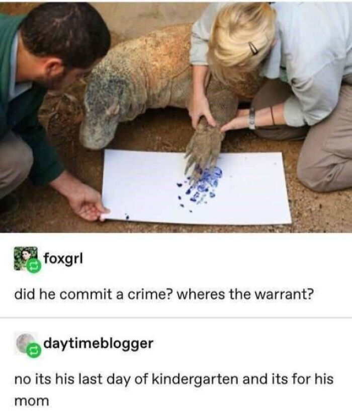 A Komodo dragon makes a blue paw print on paper, creating blessed images and positivity.