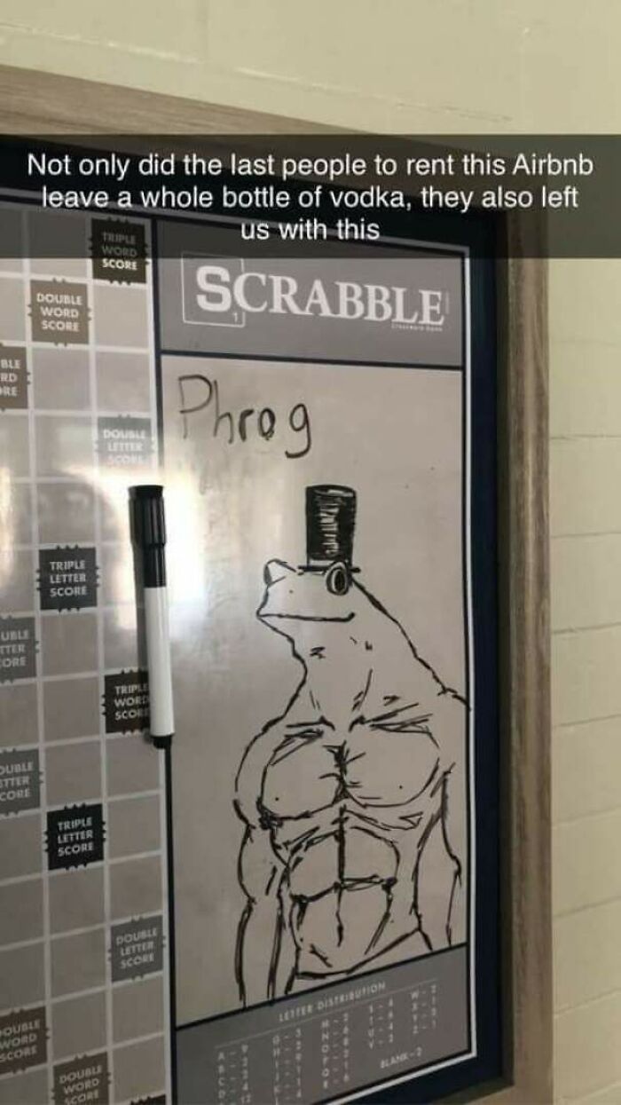 A Scrabble whiteboard with a muscular frog wearing a top hat drawn on it. A source of positivity.