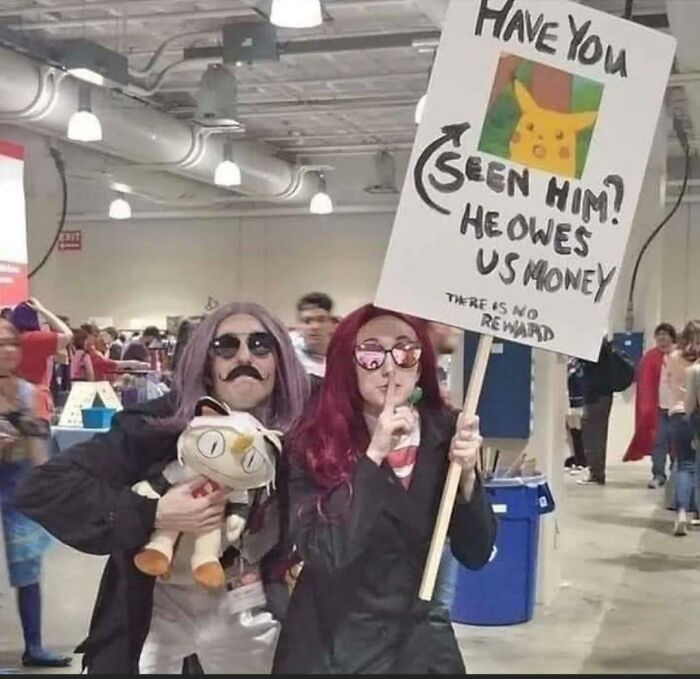 Cosplayers dressed as Team Rocket, holding a sign looking for Pikachu. A soul-healing post for positivity.