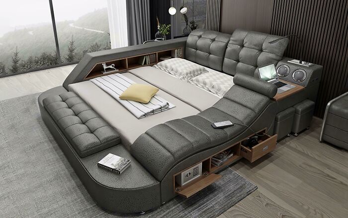A modern gray smart bed with built-in storage, speakers, and a laptop stand, symbolizing home technology.