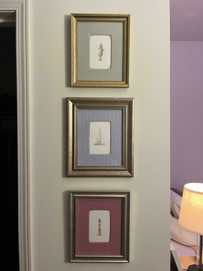 Three framed handmade nautical drawings, a fish, sailboat, and lighthouse, hanging on a light-colored wall. Handmade projects.