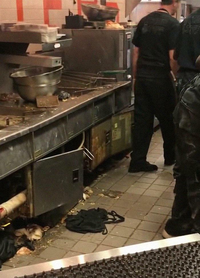 Dirty restaurant kitchen with trash and grime near cooking station