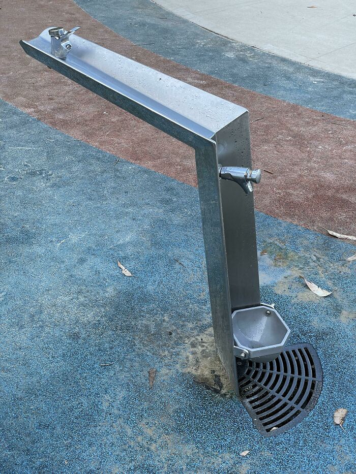 Modern outdoor water fountain cleverly combining two faucets and a drain for everyday things improvement