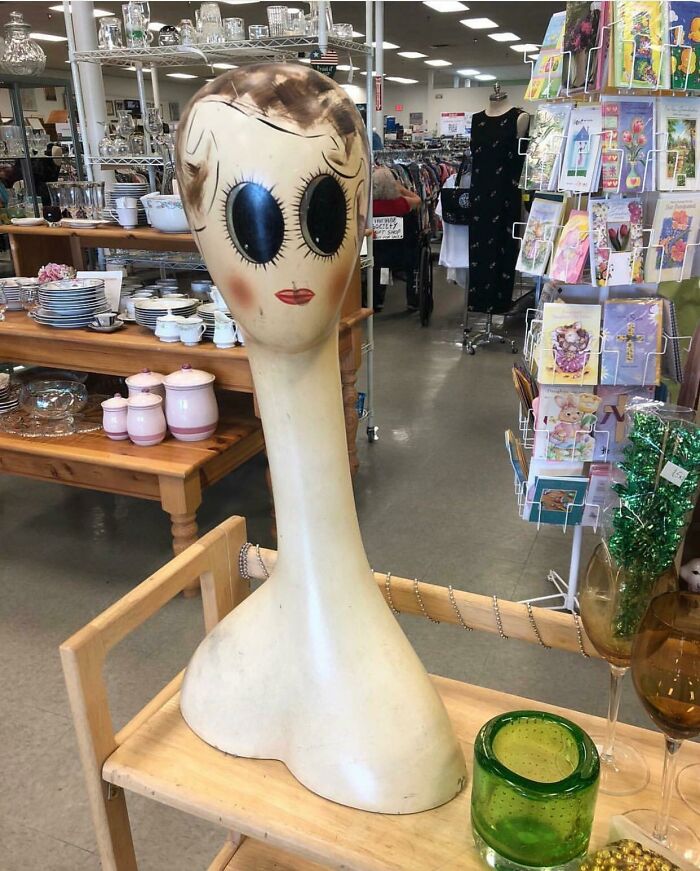 Vintage large mannequin head with big eyes in thrift store