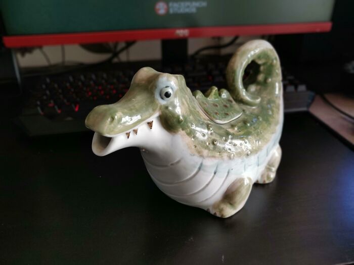 Ceramic alligator figurine with a quirky facial expression