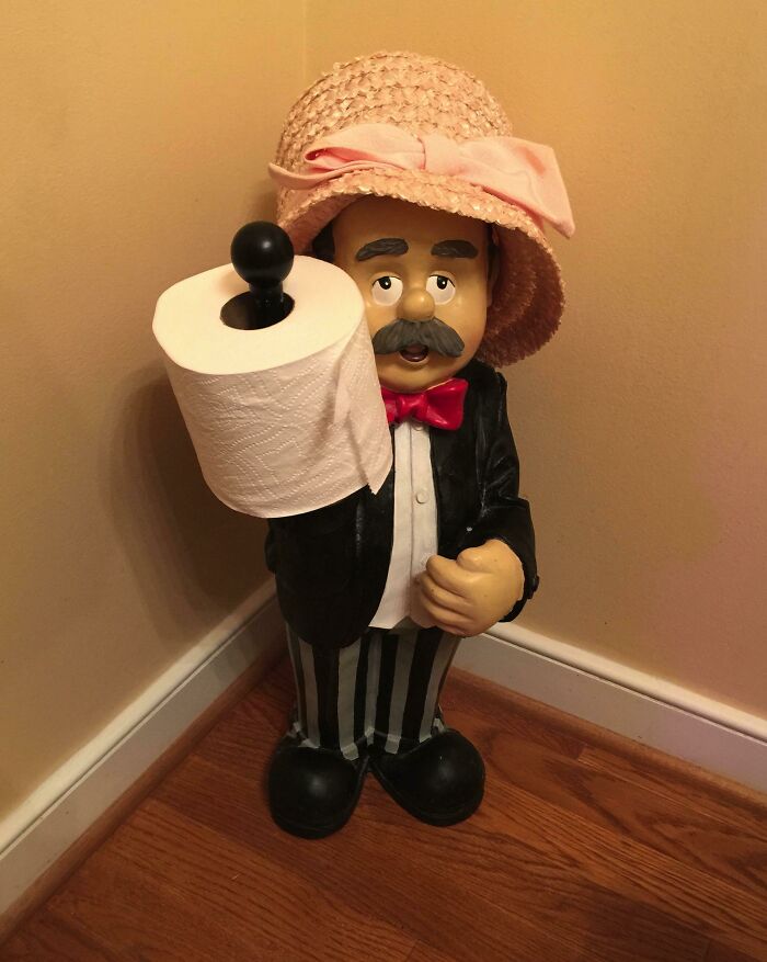 Funny figurine holding toilet paper roll wearing pink hat secondhand find