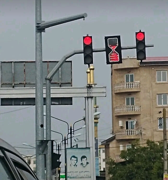 Traffic light with red light and hourglass timer for pedestrian wait time