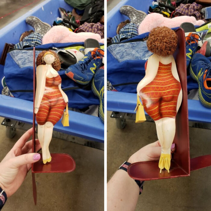 Secondhand wooden figure bookend shaped like a woman in a striped bathing suit
