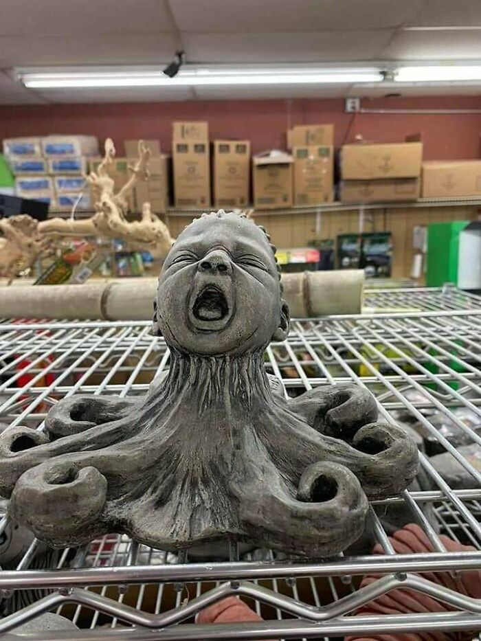 Unusual secondhand sculpture of a screaming baby with octopus tentacles