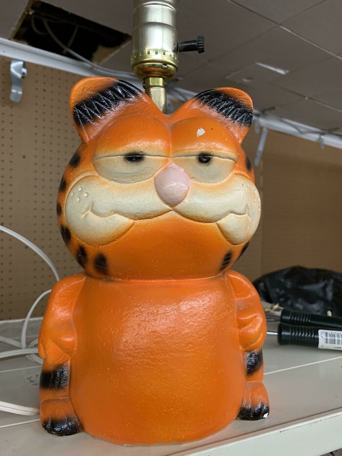 Garfield-themed lamp with tired eyes in thrift store collection