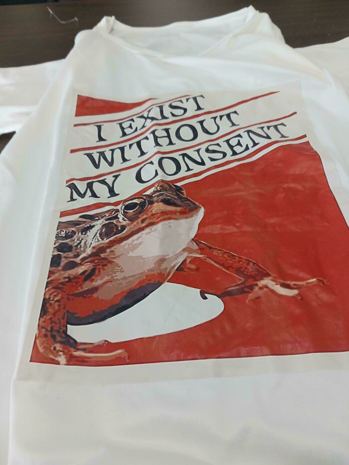 White shirt with graphic frog and text I exist without my consent