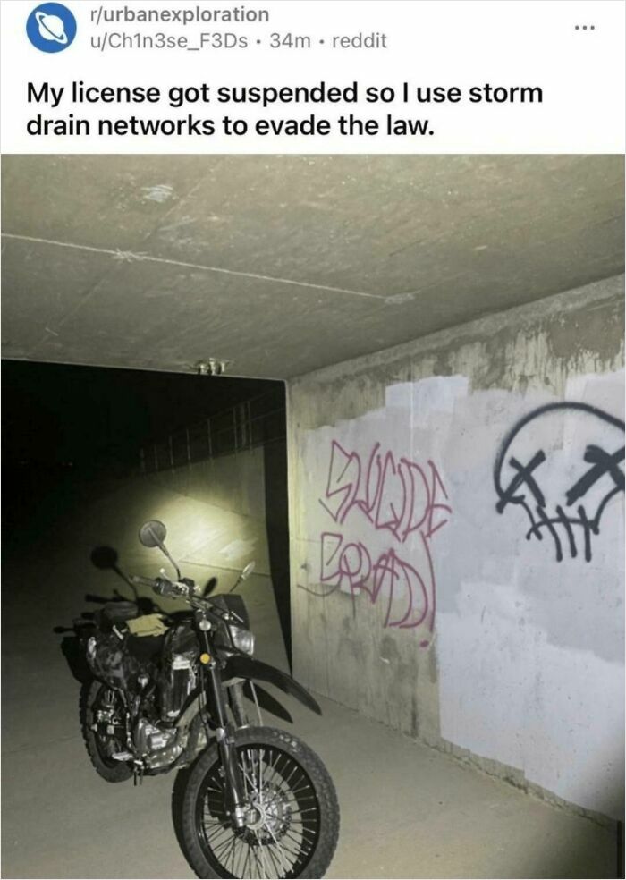 Motorcycle in graffiti-covered concrete storm drain with caption about evading law
