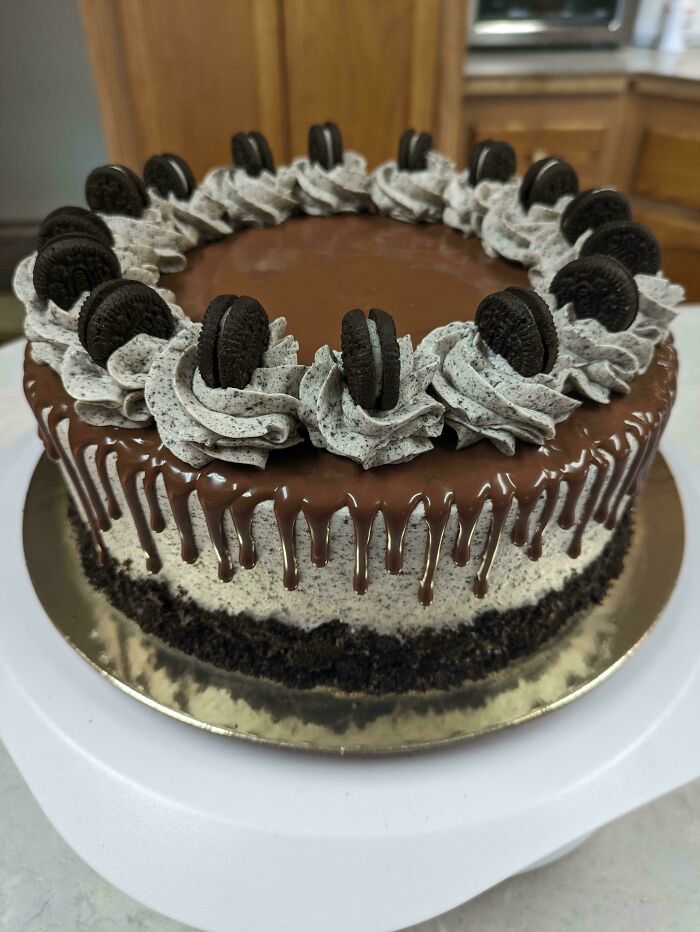 Chocolate drip cake topped with cookies and cookies and cream frosting