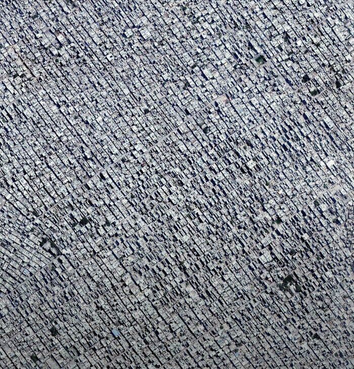 Aerial view of tightly packed urban hell city buildings and rooftops