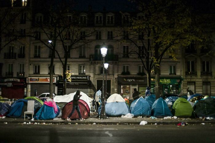 Nighttime homeless tent encampment in urban hell city street