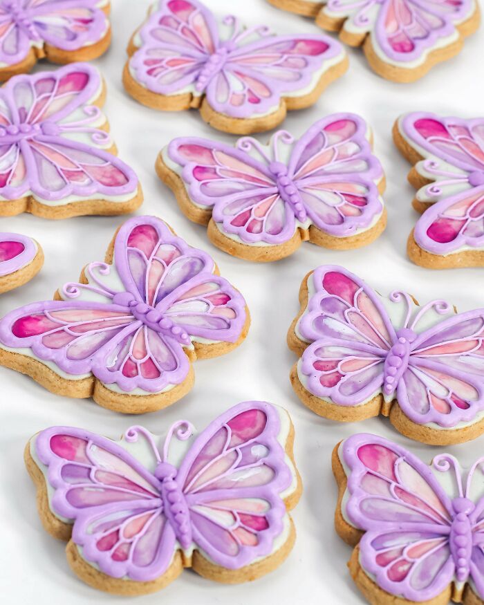 Butterfly-shaped cookies with purple and pink icing decorations