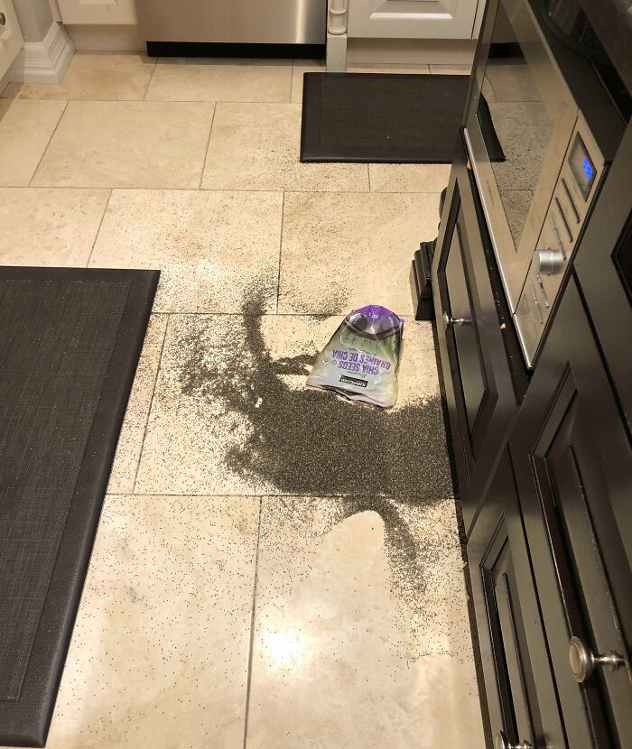 Bag of chia seeds spilled on kitchen floor creating messy kitchen fail