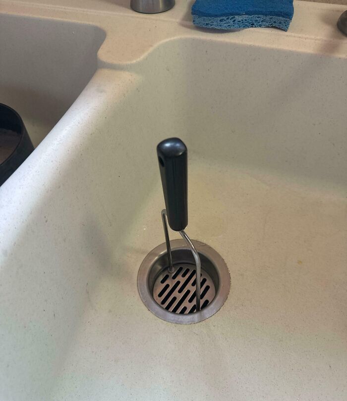 Kitchen sink drain clogged with utensil causing kitchen fail
