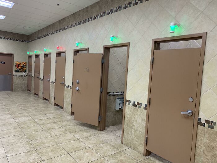 Bathroom stalls with indicator lights showing occupancy status
