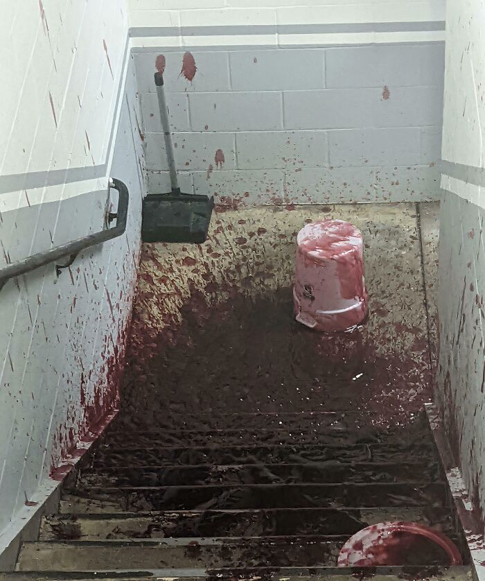 Staircase covered in spilled red liquid kitchen fail cleanup