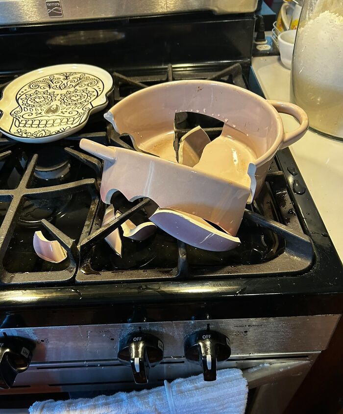 Broken ceramic cookware shattered on a stove in kitchen fail