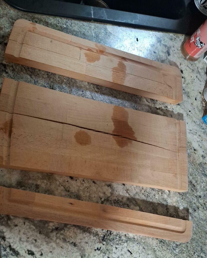 Cracked and damaged wooden cutting boards with water stains kitchen fail