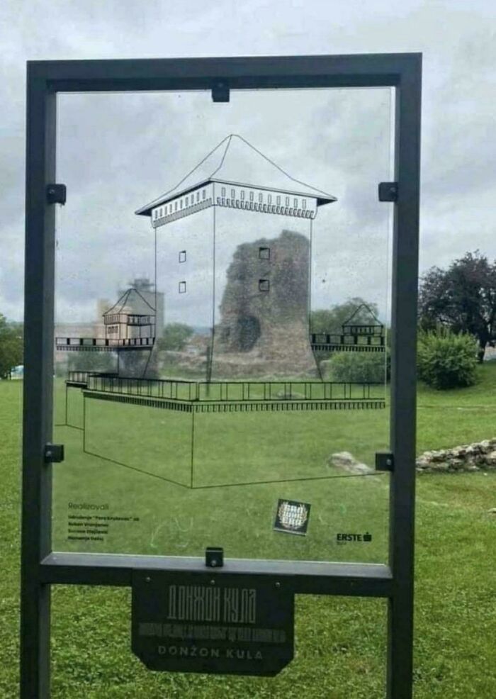 Transparent information board displays castle ruins with illustrated overlay