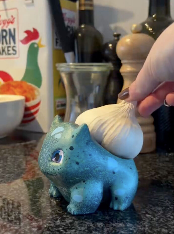 Creative garlic holder shaped like a blue creature on kitchen countertop