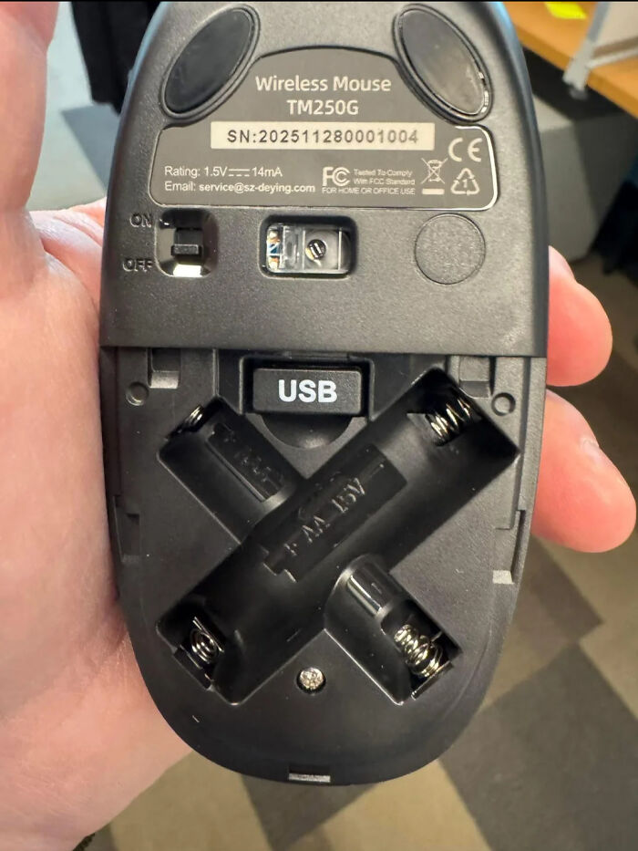 Wireless mouse showing integrated USB storage and battery compartment