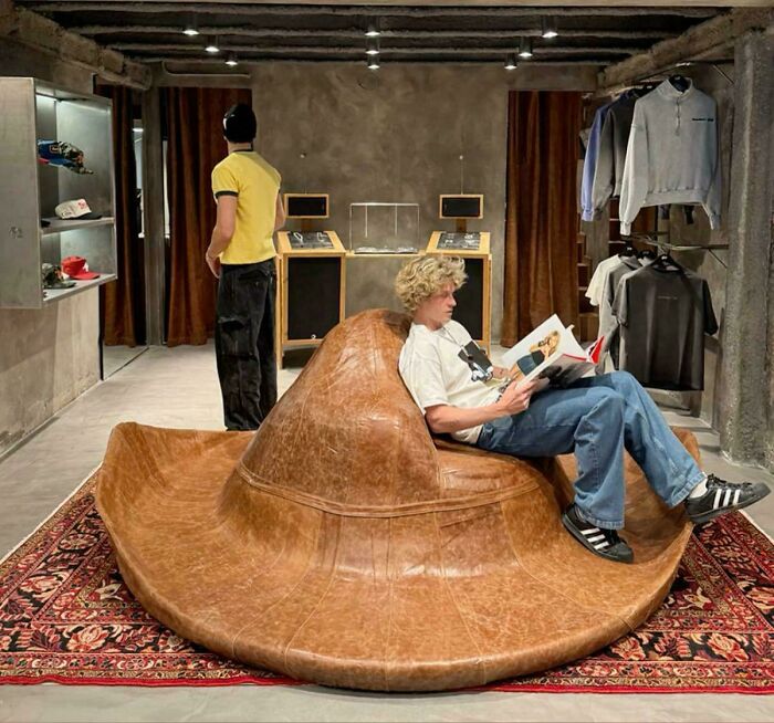 Creative leather chair shaped like a large hat in modern store interior