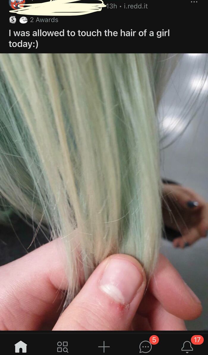 Close-up of hand touching dyed hair with funny online comment