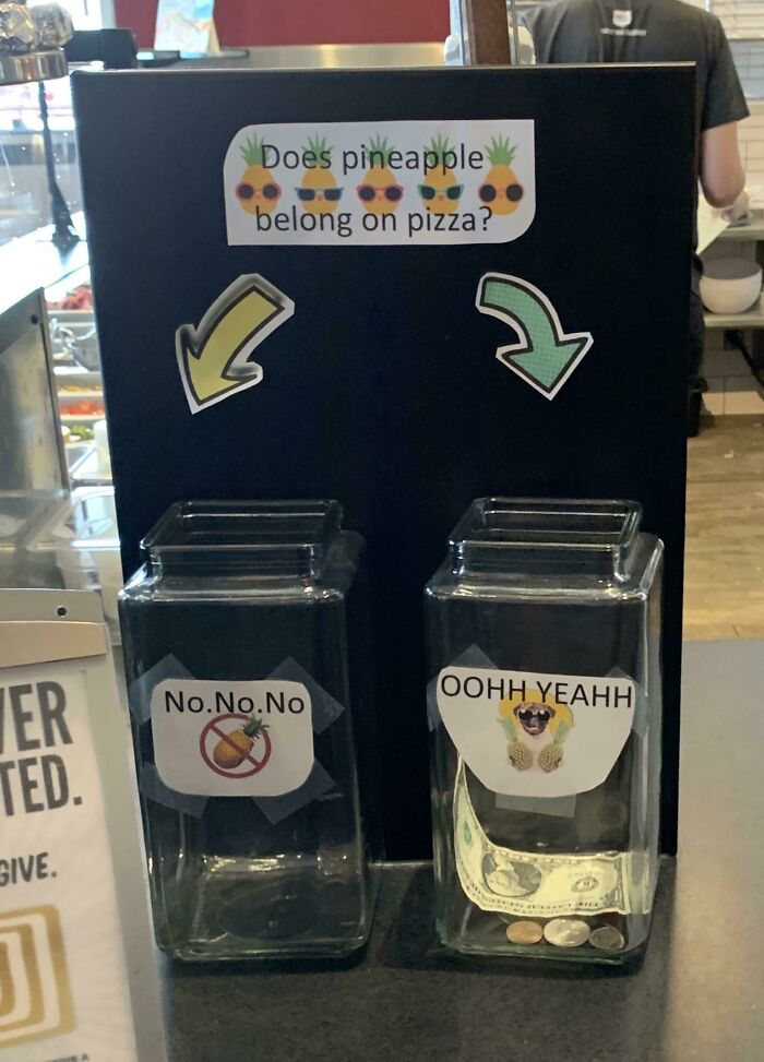 Tips jar with arrows for votes on pineapple on pizza debate