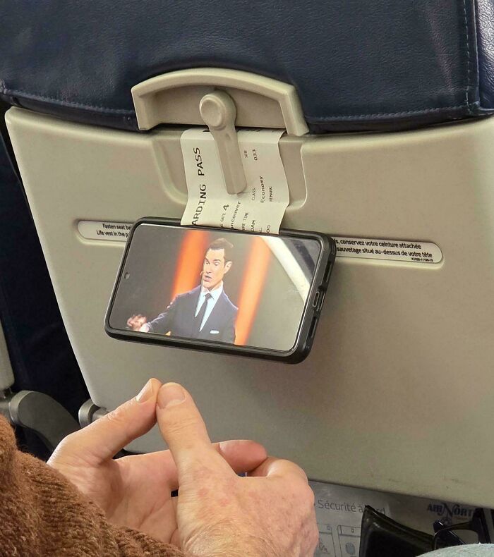 Smart phone holder using boarding pass on airplane tray