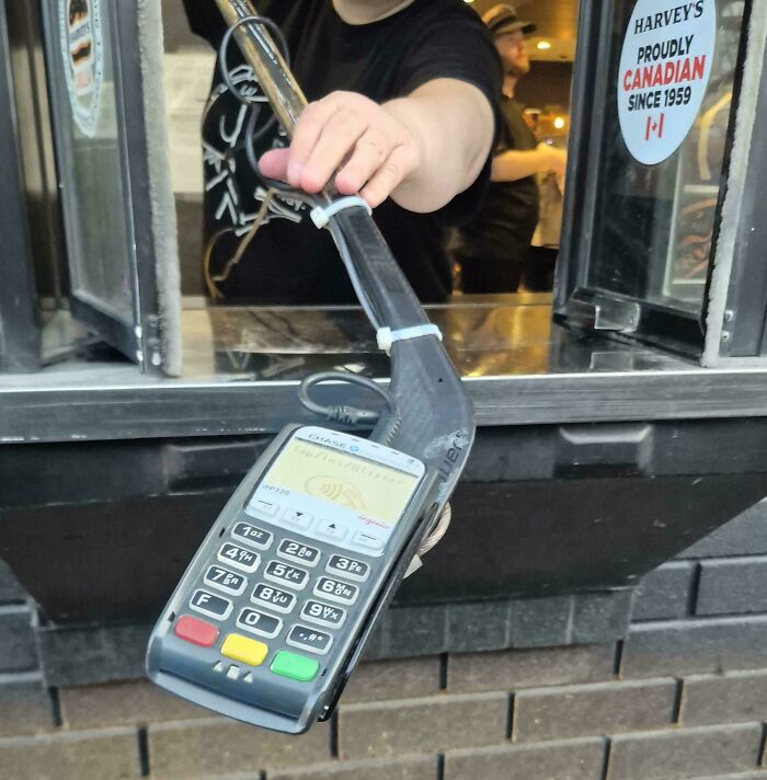 Contactless payment setup using hockey stick to hold card reader