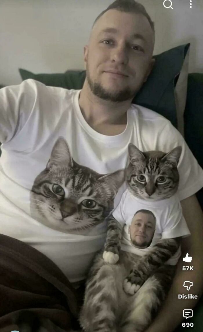 Man and cat wearing matching shirts with each other's faces printed