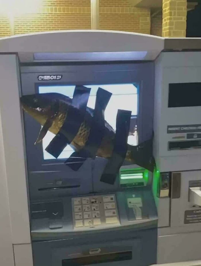 ATM machine with large fish taped over the screen