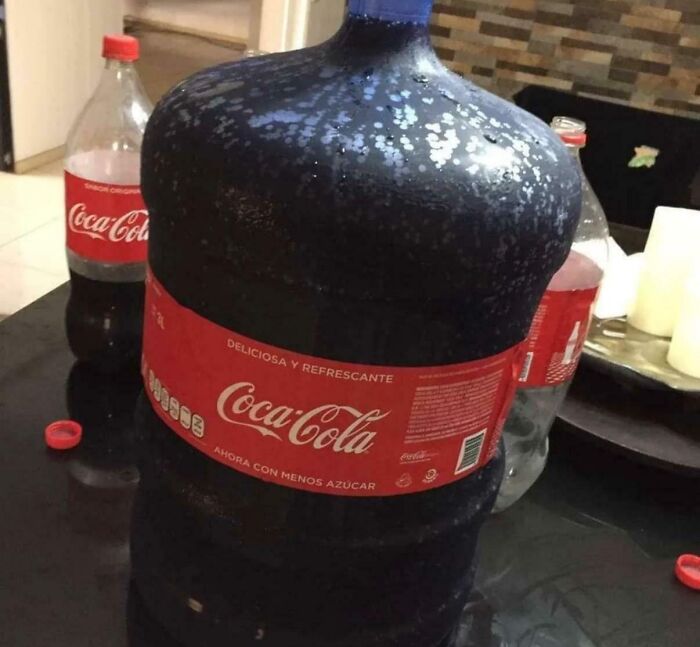 Large Coca-Cola bottle with unusual mold or discoloration on surface
