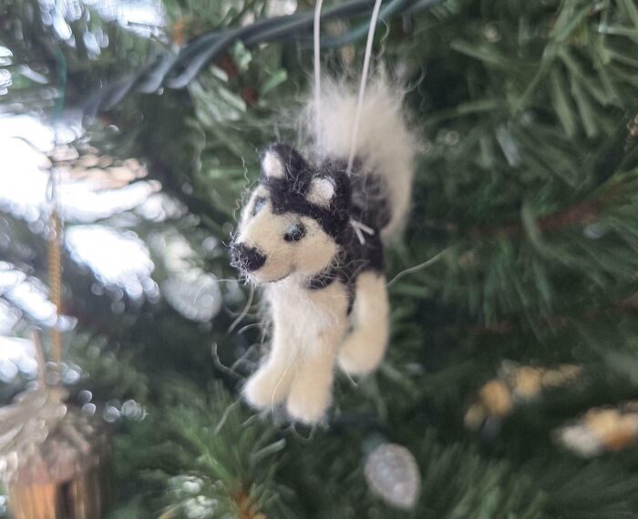 Handmade felt husky dog ornament hanging on a Christmas tree