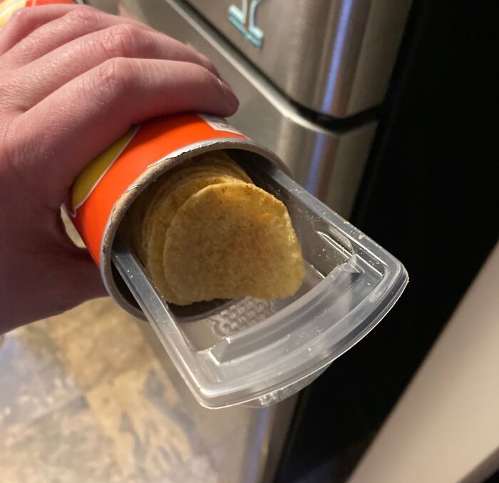 Innovative chip container with sliding tray for easy access to snack packs