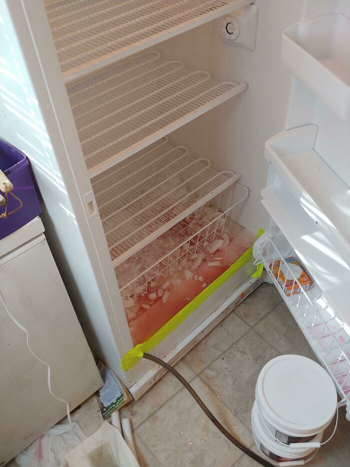 Freezer defrosting using hose drainage with tape sealing inside
